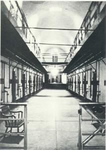 Here is the original 1847-1848 cell block that extended northward from the base of the great (94-foot-high) tower. Within this corridor were 44 cells, eleven on each side and on each story. The five steps seen in the rear led to the 1889 annex, which was built to contain another 50 cells.