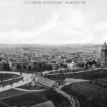 A postcard view of Penn's Common. The greenhouse, "Rustic Spring" and Saint Josephs Hospital are depicted.